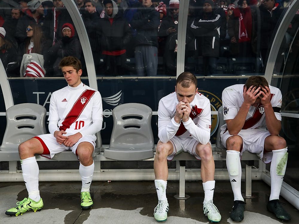 From left, freshman midfielder Justin Rennicks, junior defender Andrew Gutman and junior midfielder Jack Griffith sit on the bench while the NCAA Championship trophy is presented to Stanford after IU lost 1-0 to Stanford in overtime on Dec.10 in Chester, Pennsylvania. Stanford scored a goal in the 103rd minute of the game.