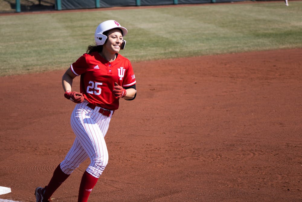 <p>Junior outfielder Cora Basset rounds the bases after hitting her first of two home runs against Western Illinois University on March 5, 2022. Indiana beat Kent State University 14-11 Wednesday afternoon.</p>