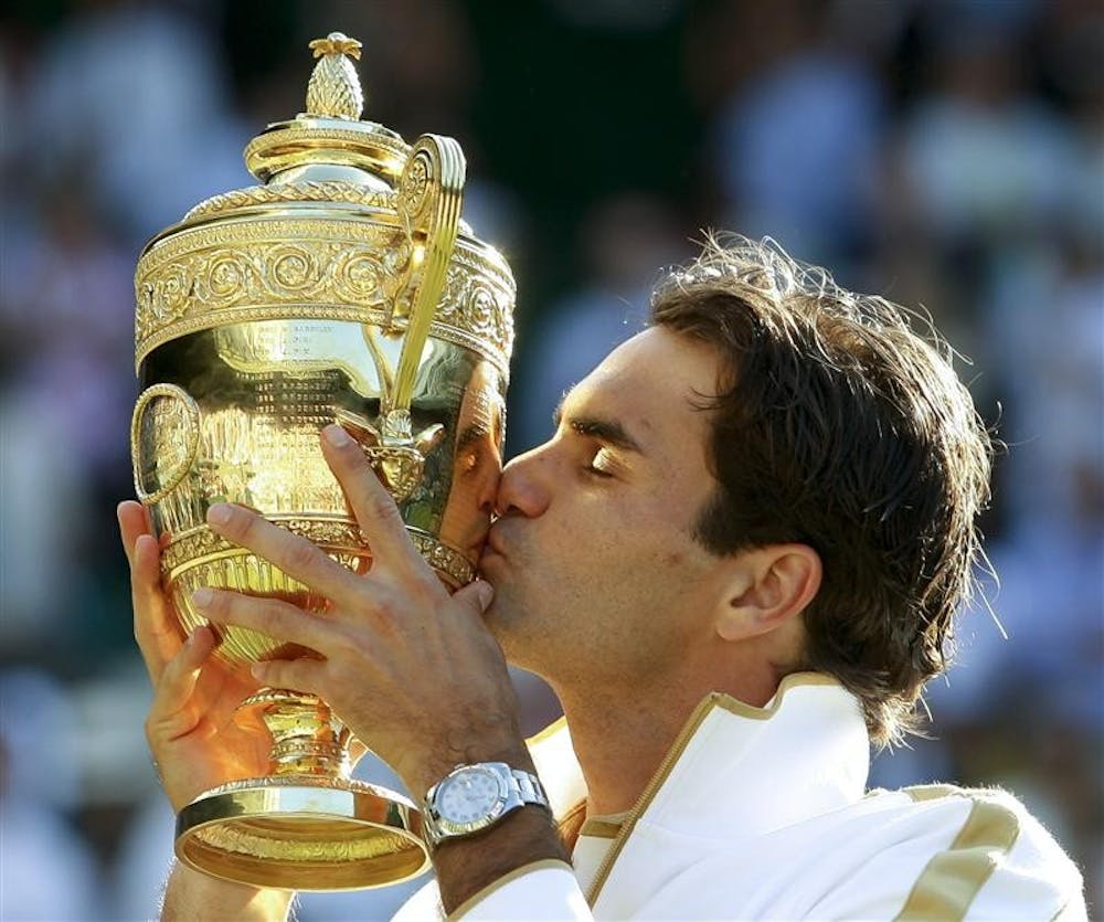 Roger Federer of Switzerland kisses the trophy after defeating Andy Roddick to win the men's singles championship on the Centre Court at Wimbledon, Sunday, July 5, 2009.