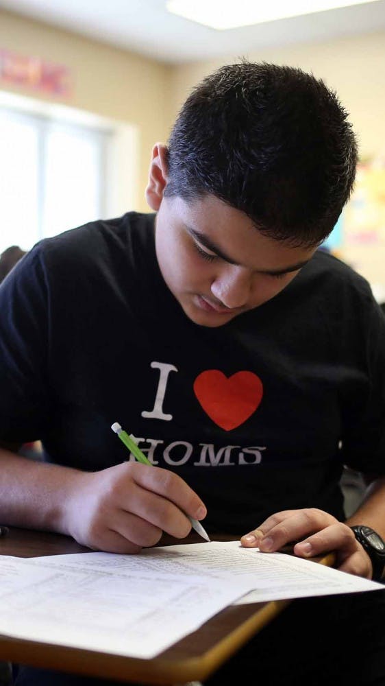 Rakan, 13, studies in first-period math at Belzer Middle School in Lawrence, Ind. on Nov. 2. He teams up with Faris, his friend at school who also speaks Arabic. Rakan helps translate for Faris even though they both know very little English. 