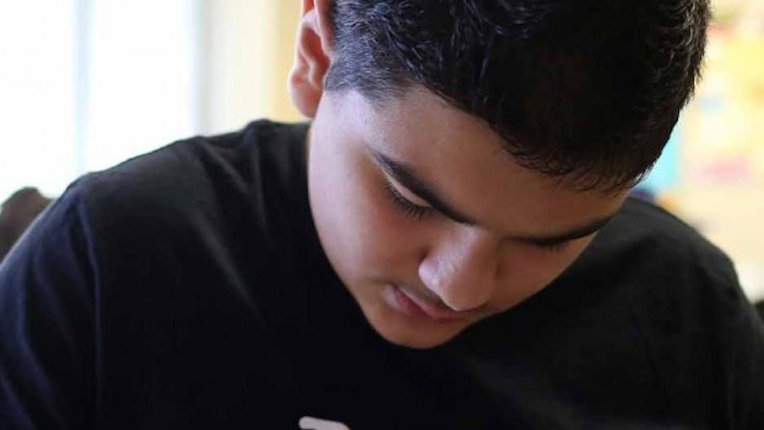 Rakan, 13, studies in first-period math at Belzer Middle School in Lawrence, Ind. on Nov. 2. He teams up with Faris, his friend at school who also speaks Arabic. Rakan helps translate for Faris even though they both know very little English. 