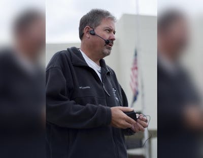 Marching Hundred Director David Woodley addresses his band in 2009 behind Assembly Hall. Woodley will step down from his directing position immediately, he announced in an open letter on the Marching Hundred’s website.