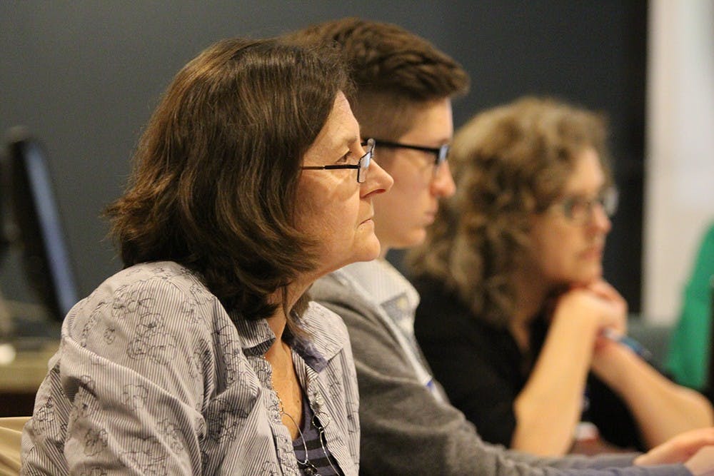 Martina Celerin, Abby Henkel, and Jean Kautt (from left) listen during a presentation proposing an artistic grant at City Hall on Wednesday. 