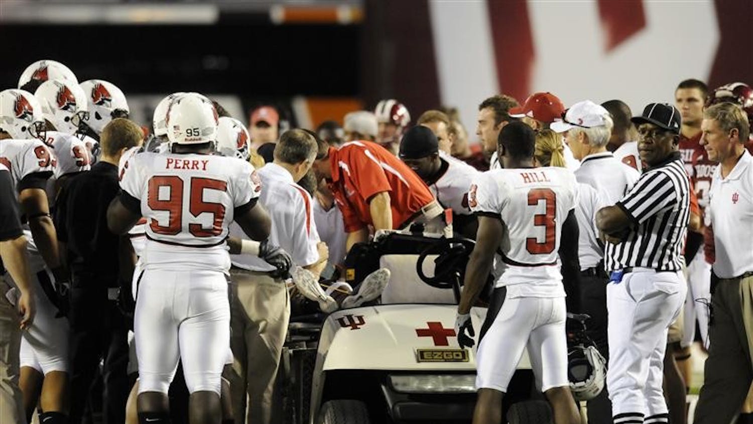 Ball State players watch as paramedics attend to teammate Dante Love after he was hit hard by a IU player in the second quarter on Saturday night at Memorial Stadium. Love lay motionless on the field for about 15 minutes as the medical staff attended to him.