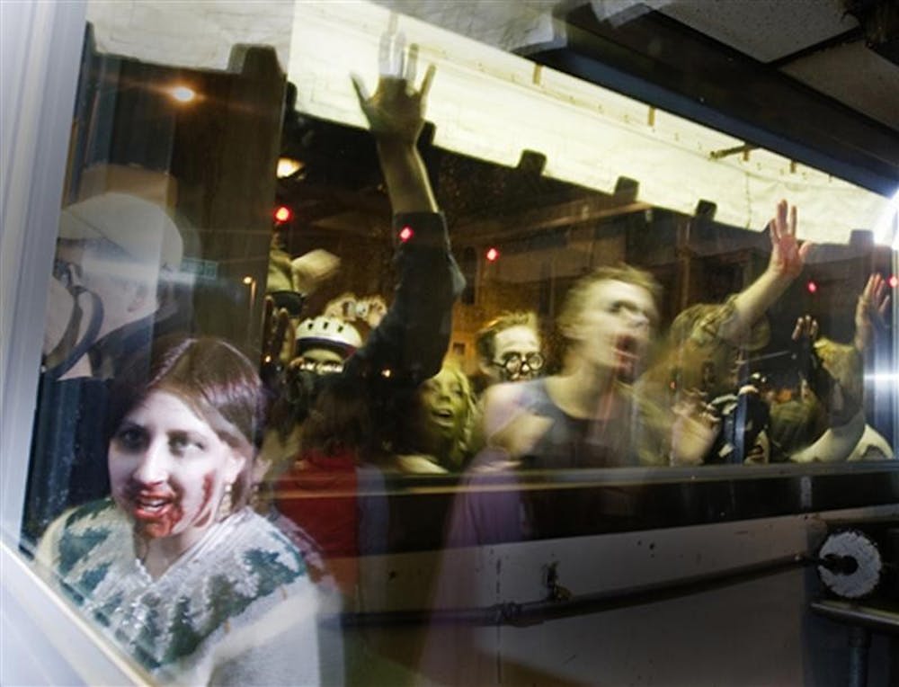 Emily Kuhn, sophomore (lower right), and others dressed as zombies claw at the windows of the Trojan Horse on Oct. 30, 2007 on Kirkwood Avenue.  The Zombie Parade is an unofficial yearly event that had been occuring for approximately five years.