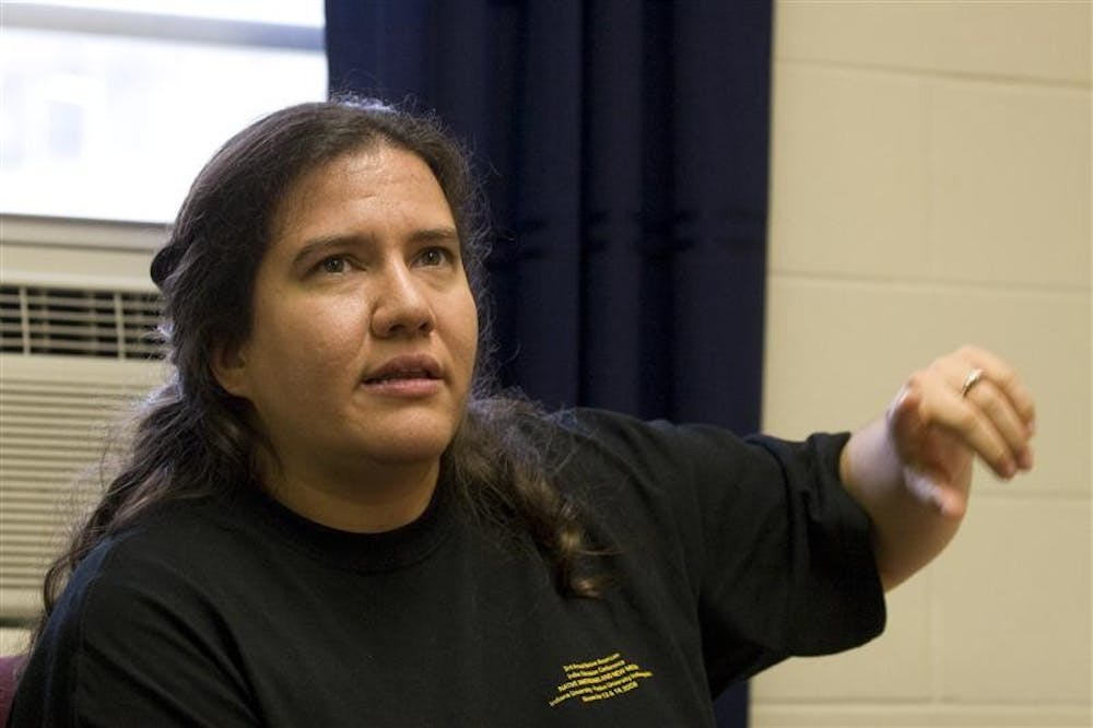 Third year graduate student Terry Miles Schuld explains the issues with how the government classifies Native Americans, during First Nations Educational and Cultural Center's open house Tuesday afternoon at their new location in Weatherly Hall. First Nations was previously located in Eigenmann Hall.