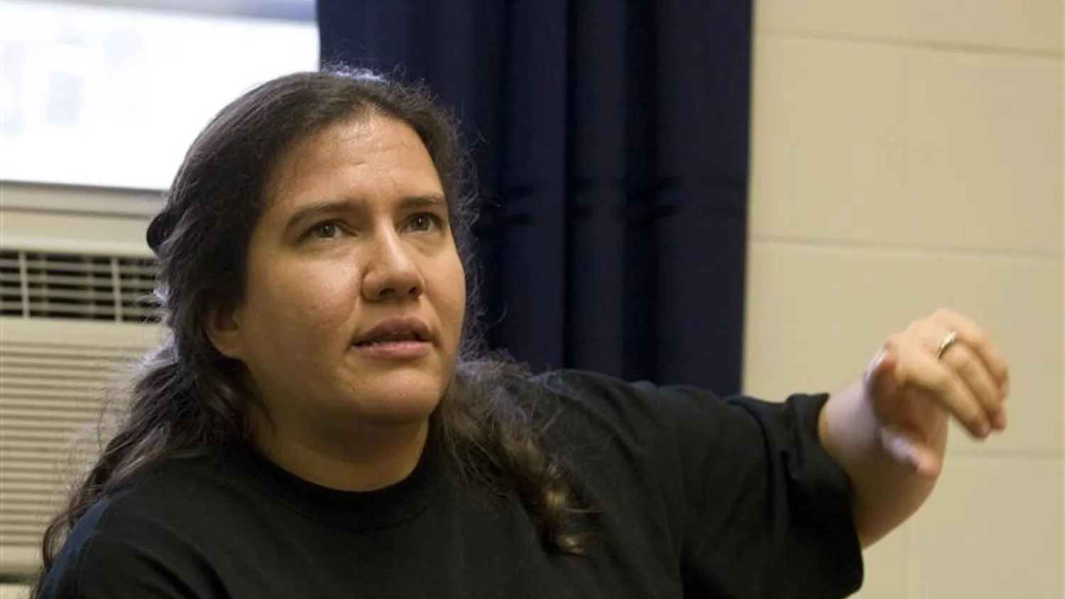 Third year graduate student Terry Miles Schuld explains the issues with how the government classifies Native Americans, during First Nations Educational and Cultural Center's open house Tuesday afternoon at their new location in Weatherly Hall. First Nations was previously located in Eigenmann Hall.