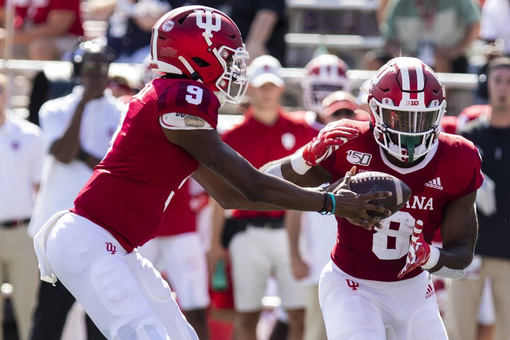 Then-freshman quarterback Michael Penix Jr. hands the ball off to then-sophomore running back Stevie Scott III on Sept. 7, 2019, at Memorial Stadium.