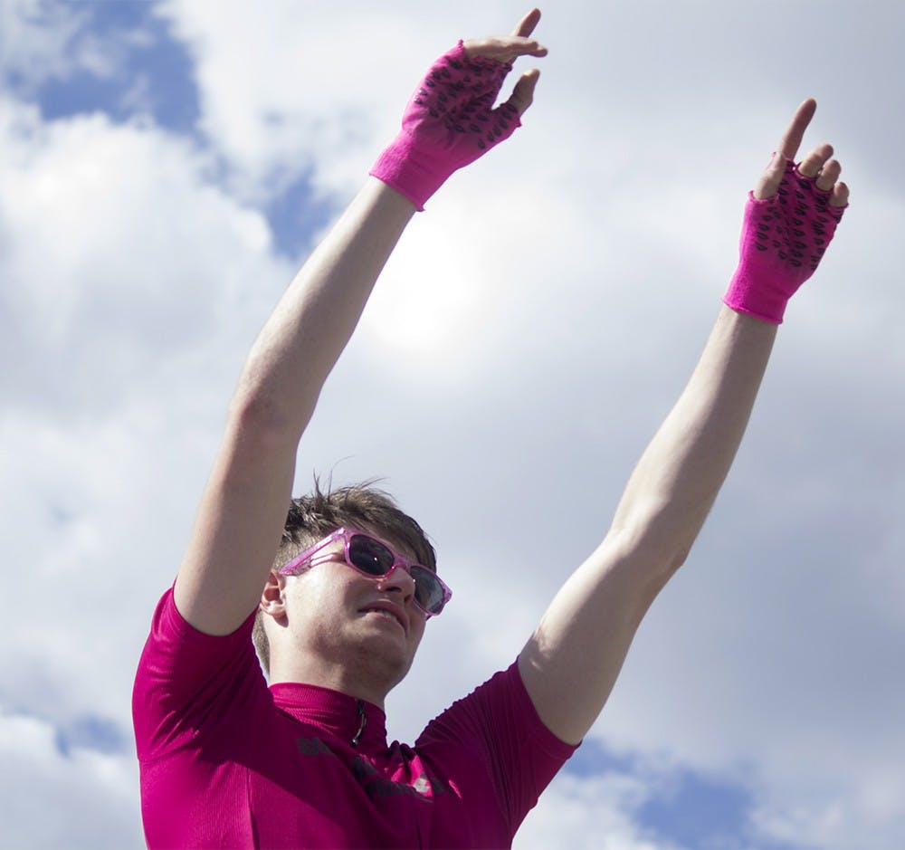 Sigma Alpha Epsilon rider Joe Krahulik points to the cheering SAE section after the team was awarded their second place Little 500 trophy.