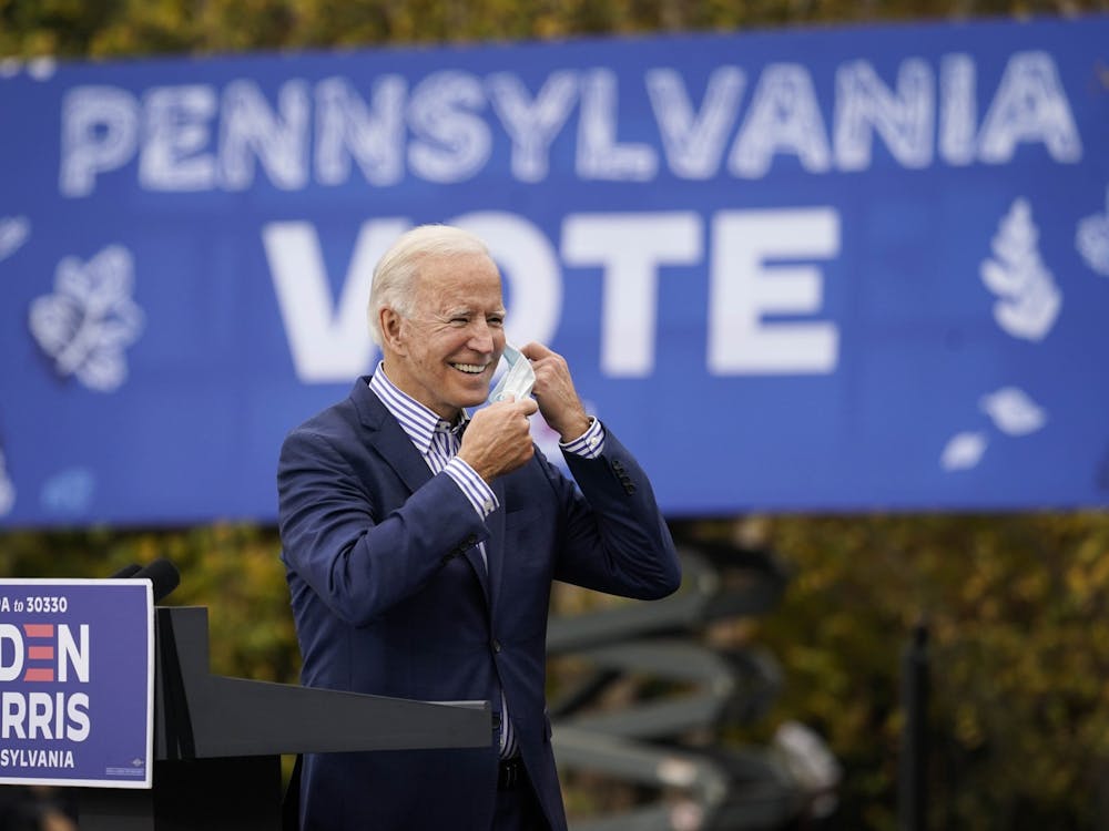 Then-Democratic presidential nominee Joe Biden takes off his face mask to speak during a drive-in campaign rally Oct. 24 at Bucks County Community College in Bristol, Pennsylvania. 