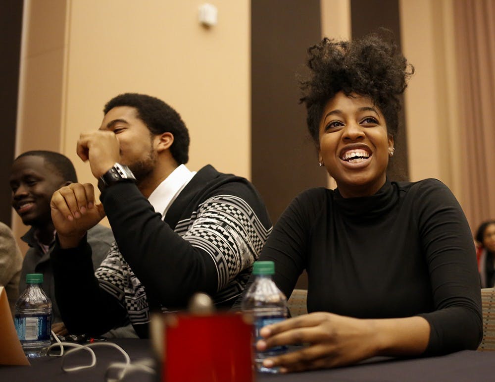 Senior Isaiah Sloss, left, and senior Aaryn Eady,right, smile after their team "High Purpose" win the Black Knowledge Bowl event Wednesday at Neal-Marshall Black Culture Center. Black Knowledge Bowl is is an academically competitive program which tests student knowledge regarding the history and politics of African Americans in the United States, started in 1983. 