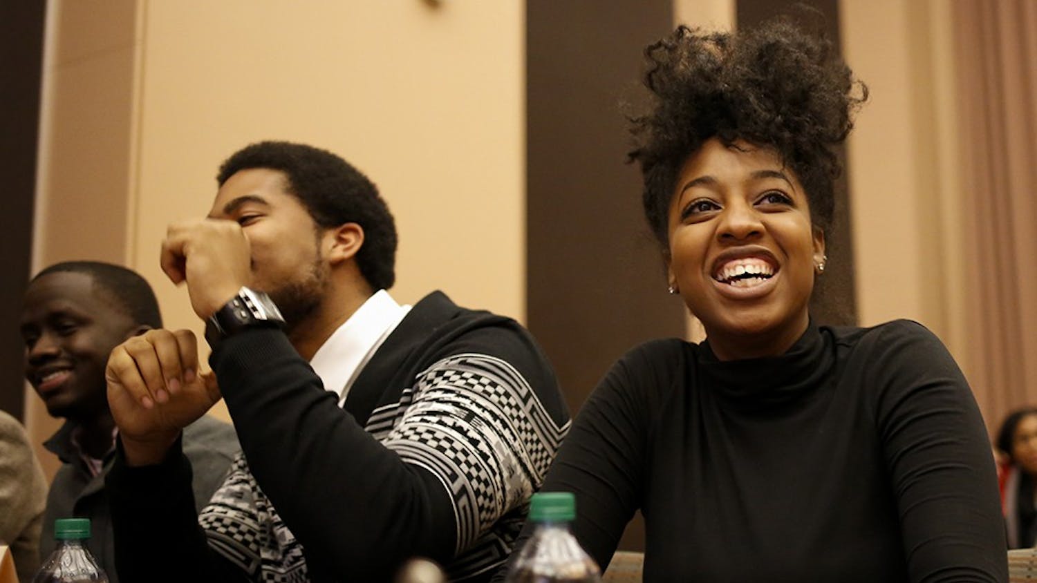 Senior Isaiah Sloss, left, and senior Aaryn Eady,right, smile after their team "High Purpose" win the Black Knowledge Bowl event Wednesday at Neal-Marshall Black Culture Center. Black Knowledge Bowl is is an academically competitive program which tests student knowledge regarding the history and politics of African Americans in the United States, started in 1983.