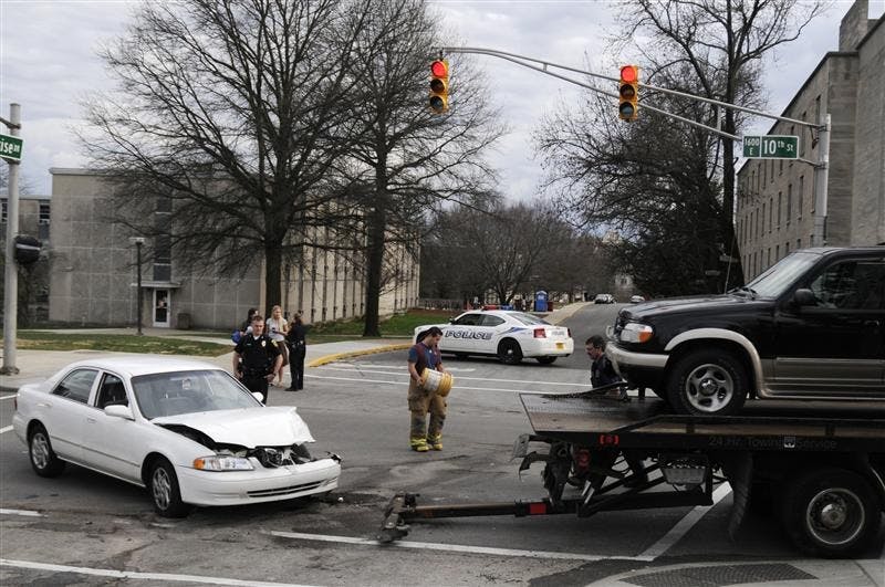 Responders work to clean up an accident Friday at the intersection of 10th Street and Sunrise Drive on the IU campus. IUPD officers closed 10th Street in one block each direction to allow crews to clear the road, causing traffic headaches for some trying to drive across campus.