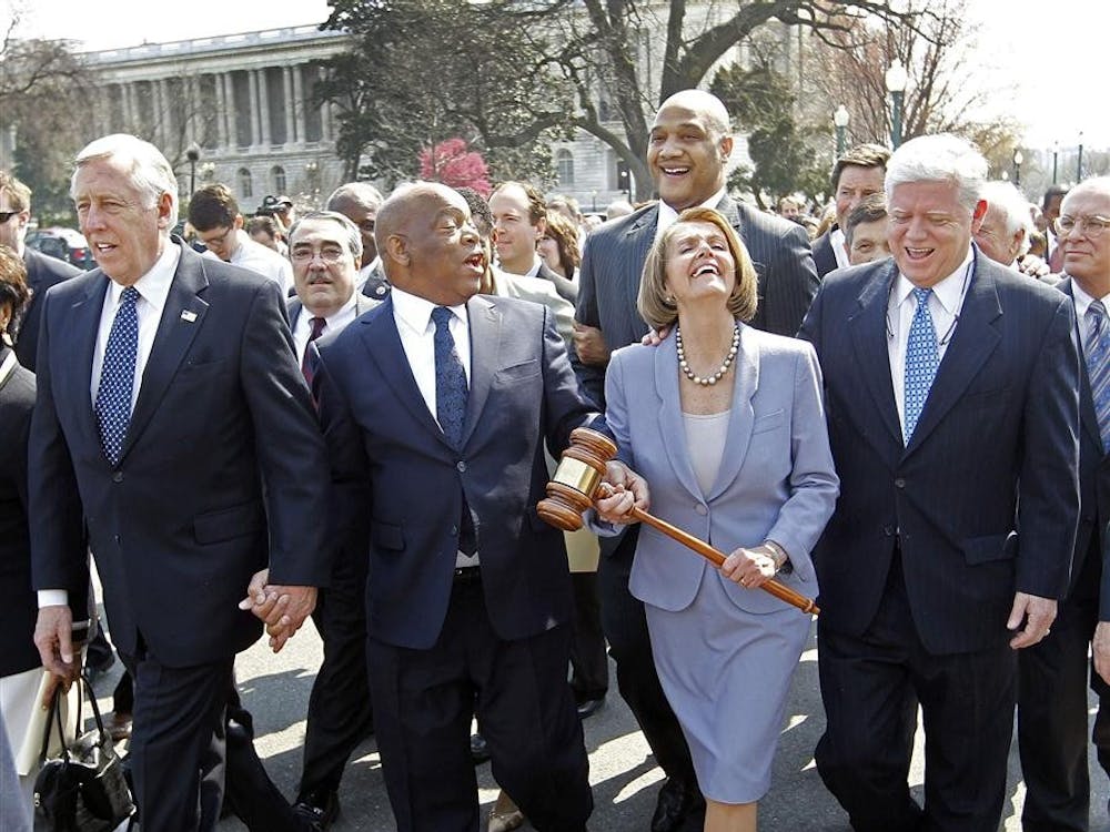Speaker Nancy Pelosi  of California holding the gavel used to pass Medicare Reform, laughs as she walks across the street and into the U.S. Capitol as the House prepares to vote on health care reform in the U.S. Capitol in Washington, Sunday, March 21, 2010. Walking with Speaker Pelosi are from left, Rep. Steny Hoyer, D-Md., Rep. John Lewis, D-Ga., and Rep. John Larson, D-Conn. 