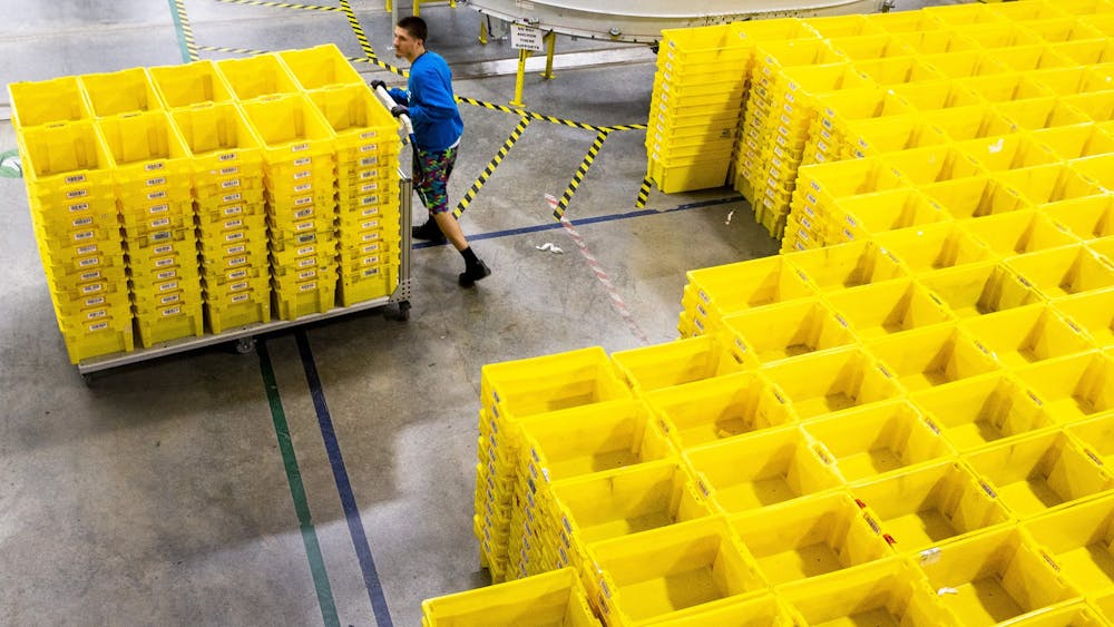 An employee organizes crates at an Amazon fulfillment center in Grapevine, Texas, on December 5, 2018.