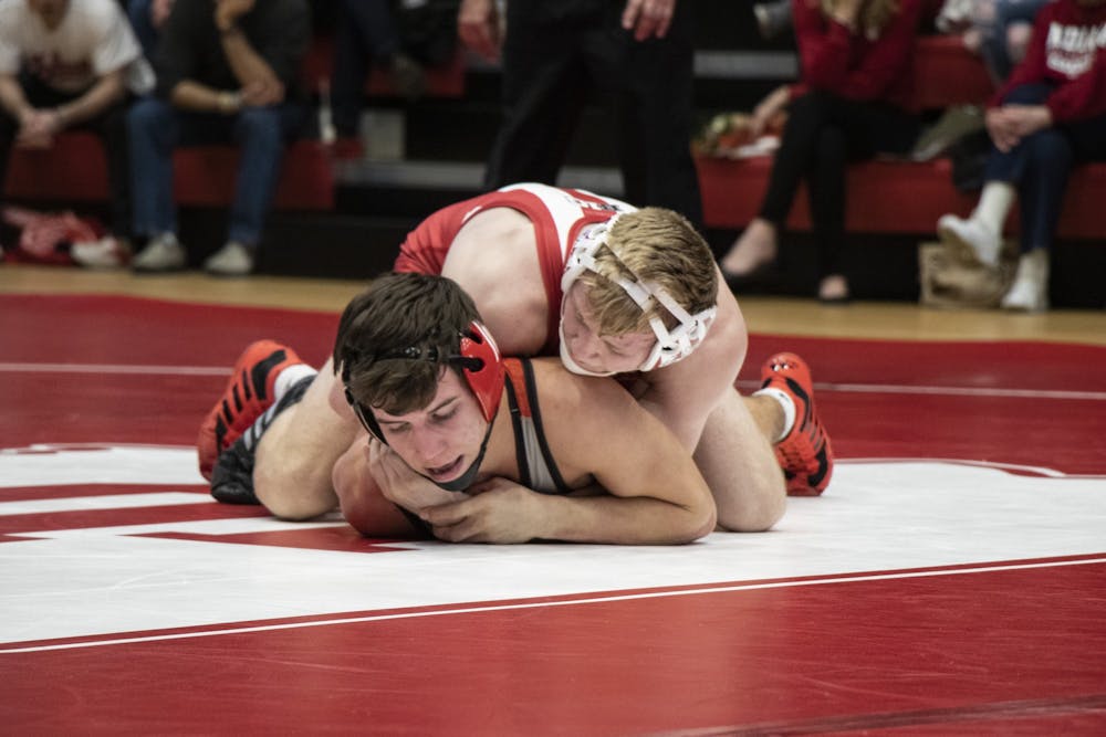 <p>Freshman Cayden Rooks holds down Southern Illinois University Edwardsville redshirt sophomore Jacob Blaha on Feb. 16 in Wilkinson Hall. IU defeated SIUE 24-11.</p>