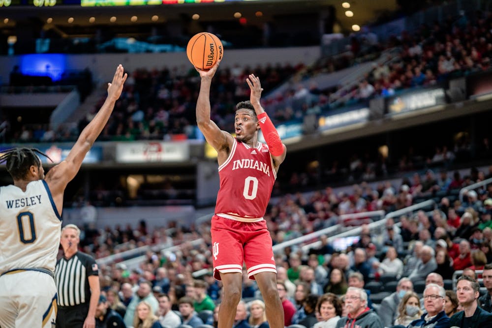 <p>Senior guard Xavier Johnson shoots a three during the second half of the Crossroads Classic between Indiana and Notre Dame on Dec. 18, 2021, in Gainbridge Fieldhouse in Indianapolis. Johnson had 11 points in 32 minutes of playing time against Notre Dame.</p>