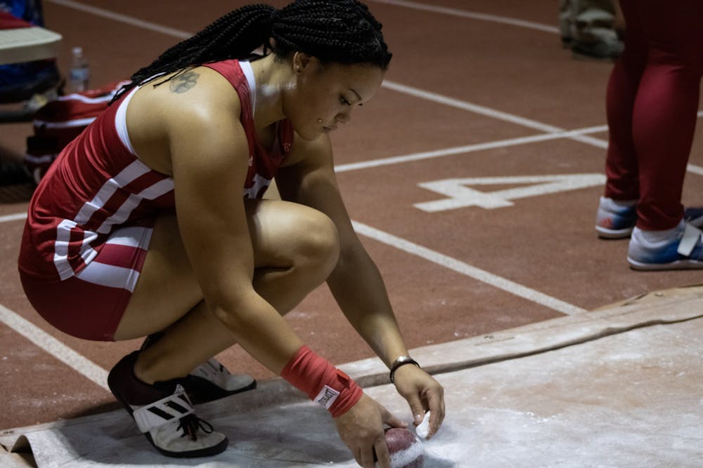 <p>Freshman Jayden Ulrich puts chalk on her shot put ball at the Hoosier Hills meet Feb. 11, 2022, at the Harry Gladstein Fieldhouse. Multiple Indiana athletes set new personal records or broke program records at the Penn Relays over the weekend.</p>