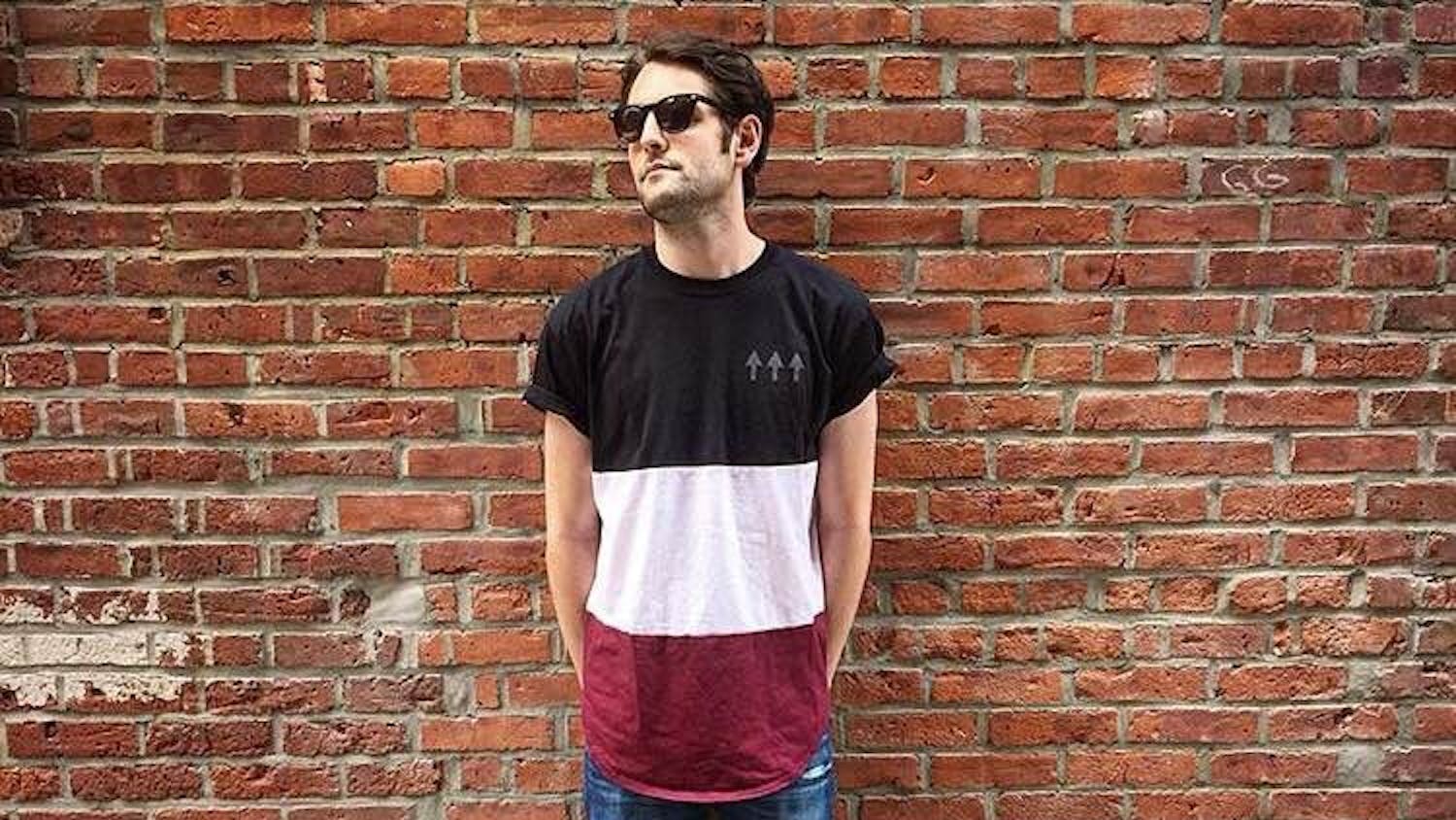 Corey Rosenblum, owner of Sky Culture Clothing poses with three-panel "triple arrow tee.". Sky Culture is a clothing company focusing on urban hip hop and arts.