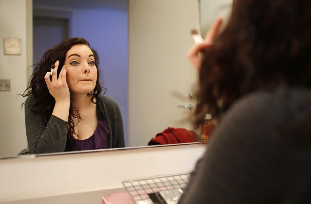 Lauren Sagendorph puts on the finishing touches of her makeup in the woman's dressing room of the IU Theater Building before the start of the dress rehearsal for the play "SIng to Me Now" on Mar. 24. She played the character Yankee in the show and it was her acting debut with the IU Theater Department. 
