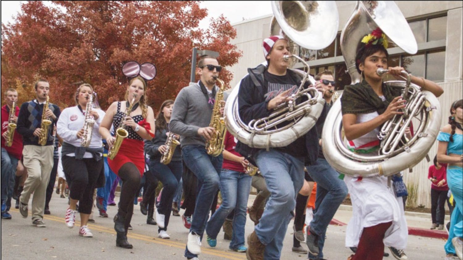 Members of the Marching Hundred parade down Kirkwood Avenue during homecoming festivities in 2013.