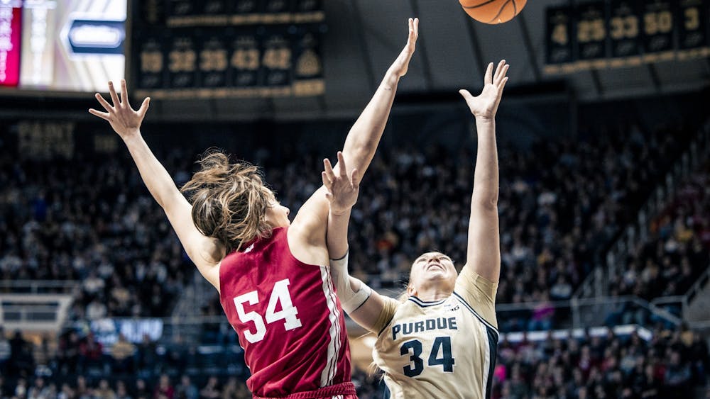 Senior forward Mackenzie Holmes attempts to block a shot in West Lafayette on Feb. 5, 2023. Holmes moved into second place on Indiana&#x27;s all-time blocks list.