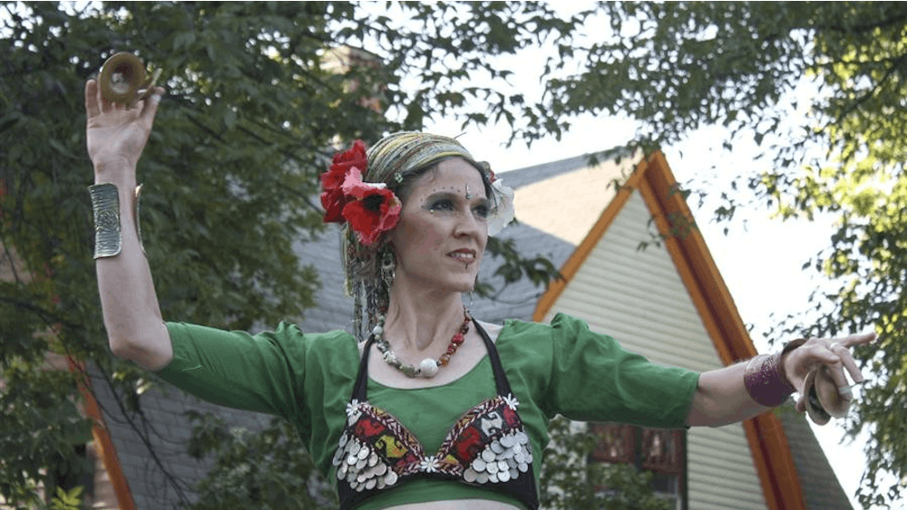 Bloomington resident Alice Dobie-Gluska performs with members of Dark Side Tribal on Saturday at the Flavors of Fourth Street International Food Festival.