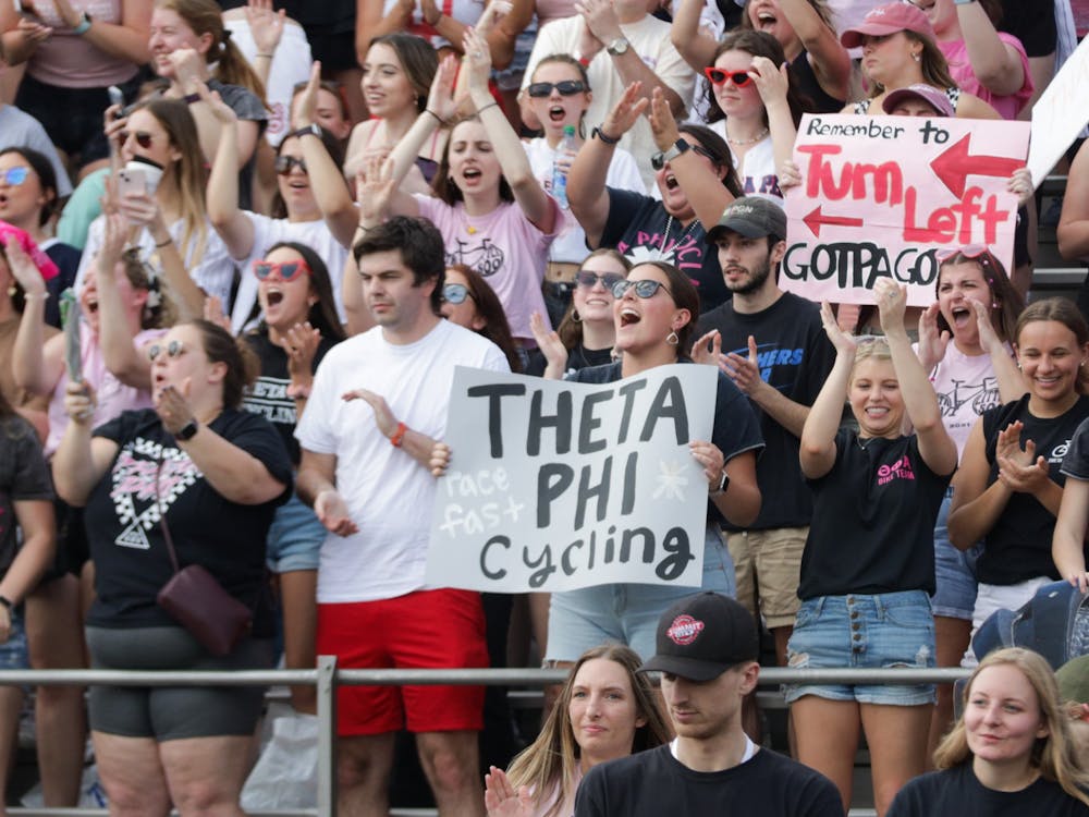 Fans hold a sign that reads &quot;Theta Phi Cycling&quot; April 22, 2022, at Bill Armstrong Stadium. Many fans had posters to cheer on their team. 
