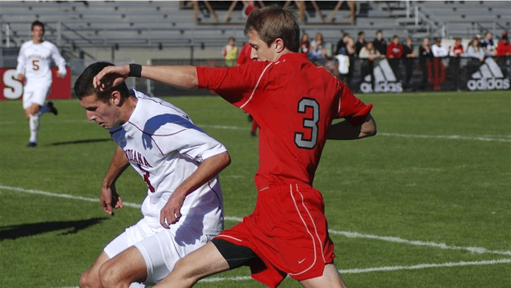 Sophomore defender Tommy Meyer avoids Ohio State's Eric Shrigley's foot near the Hoosier goal Sunday at Bill Armstrong Stadium. Both teams remained scoreless in regulation, with the Buckeyes pulling out a 1-0 win in overtime.