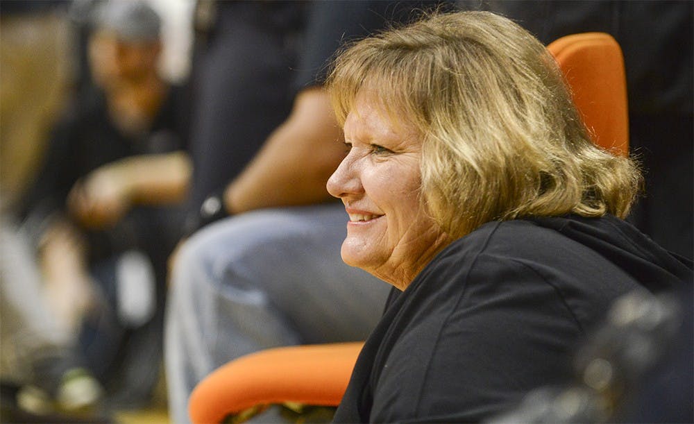 While the Firecrackers perform during halftime, their coach Lynn Kelley watches from the sideline Saturday at Assembly Hall.