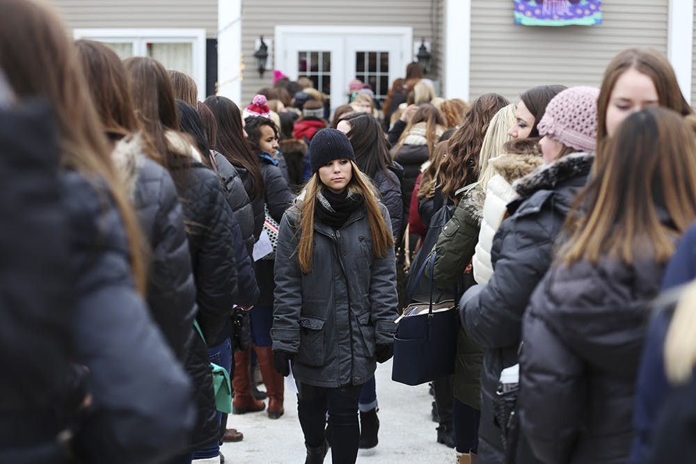 Prospective sorority members line up outside the Delta Zeta house Thursday afternoon during recruitment. 
