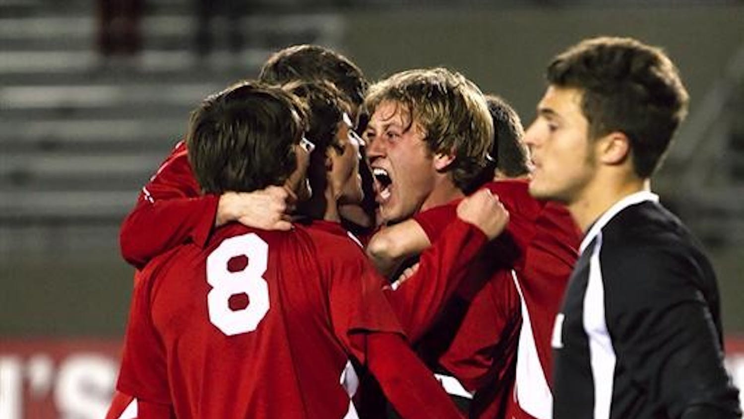 Senior midfielder Brad Ring (center) celebrates with teammates following his first goal of the season in the 77th minute of the Hoosiers 3-0 NCAA Tournament win Saturday against Michigan at Bill Armstrong Stadium.