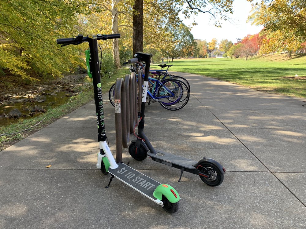 <p>A Lime and Bird scooter are parked outside the Indiana Memorial Union Oct. 29, 2018. Lime is hosting rider safety workshops in partnership with IUPD.</p>