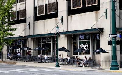 People sit outside of Yogi’s Bar and Grill on May 16 along Walnut Street. Multiple restaurants in Bloomington have expanded outdoor seating to encourage social distancing.