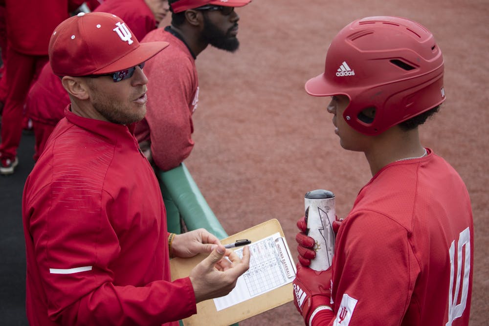<p>Then-sophomore infielder Justin Walker talks to IU baseball head coach Jeff Mercer at Bart Kaufman Field on April 28, 2019. Indiana earned an important series win against Minnesota this past weekend.</p>