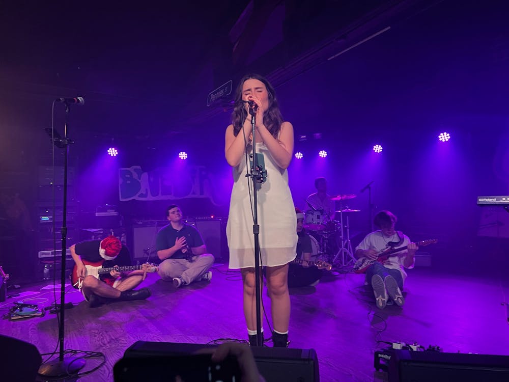IU senior and Street Pennies vocalist Ollie Grcich sings a heartfelt melody while her band members sit behind her Dec. 10, 2022, at The Bluebird. The band performed their one year anniversary show at The Bluebird. 