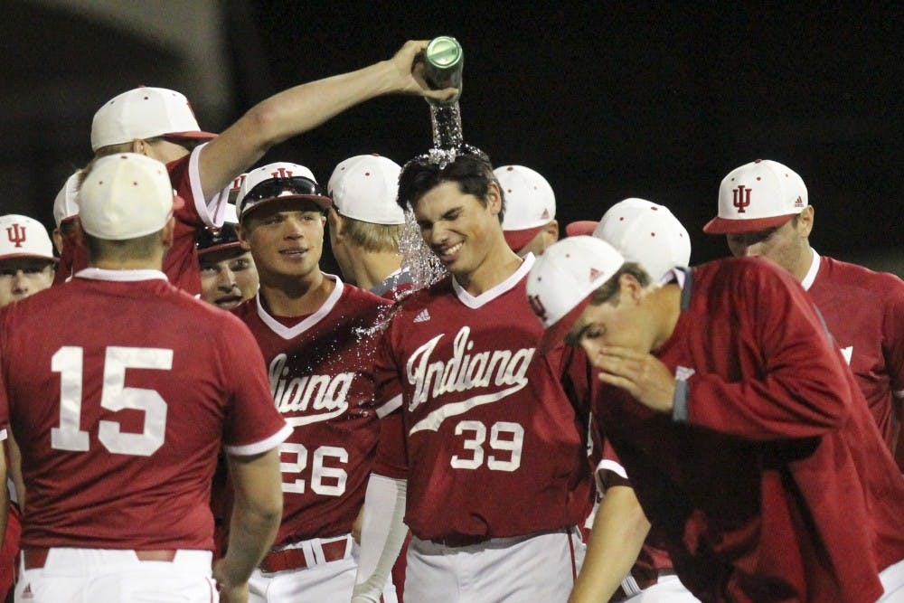 Teammates pour water over junior outfielder Craig Dedelow's head after beating Northwestern in the second game of a doubleheader on Friday night. An error by the Northwestern first baseman allowed Dedelow to get to first and the Hoosiers to win 4-3.