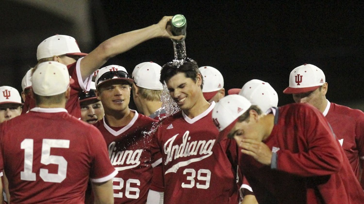Teammates pour water over junior outfielder Craig Dedelow's head after beating Northwestern in the second game of a doubleheader on Friday night. An error by the Northwestern first baseman allowed Dedelow to get to first and the Hoosiers to win 4-3.