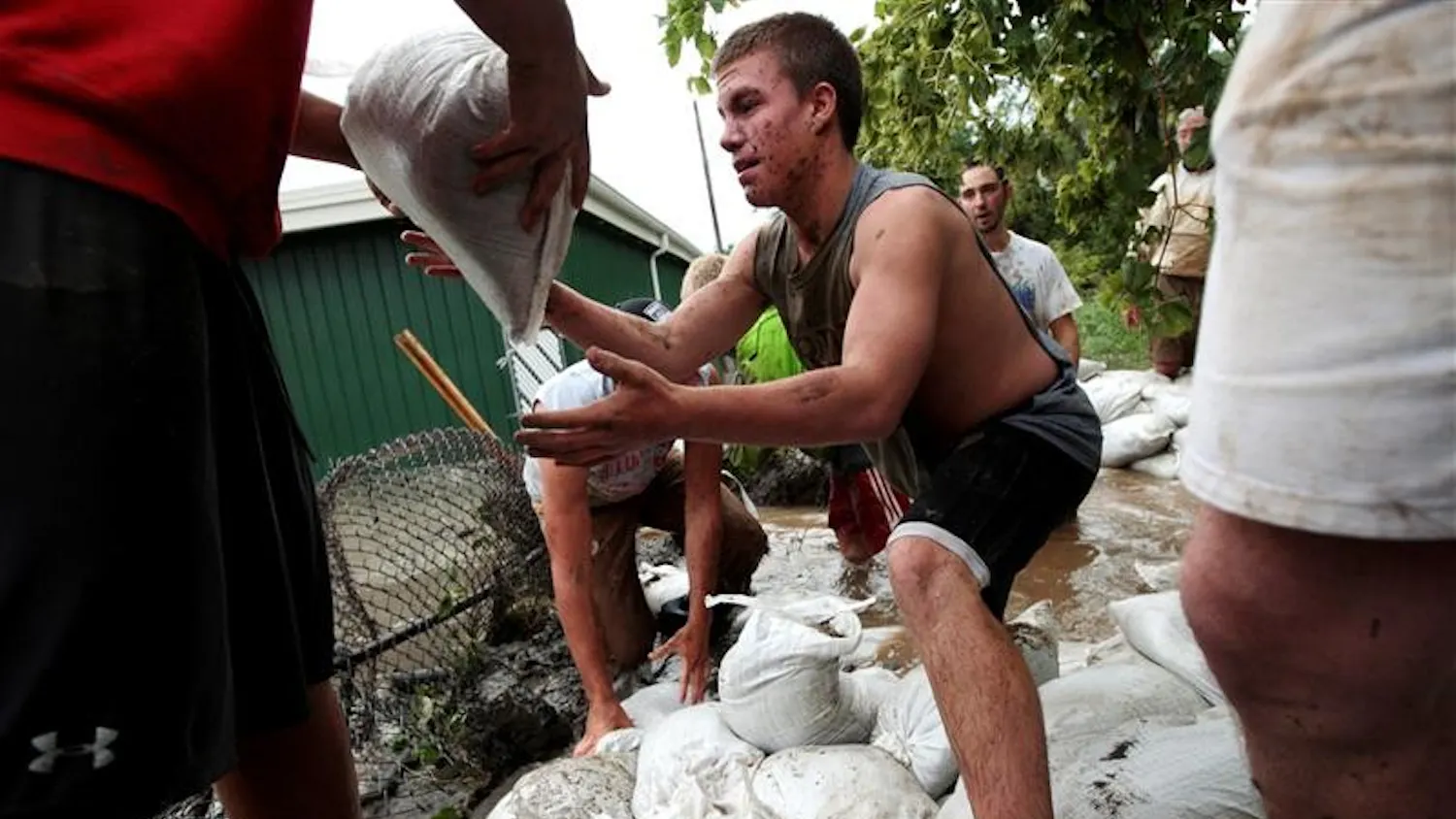 Colin Hammermeister, a Munster, Ind. high school football player, helps patch up areas along the Little Calumet on Sunday after the Little Calumet river spilled its banks flooding Munster and Hammond, Ind.