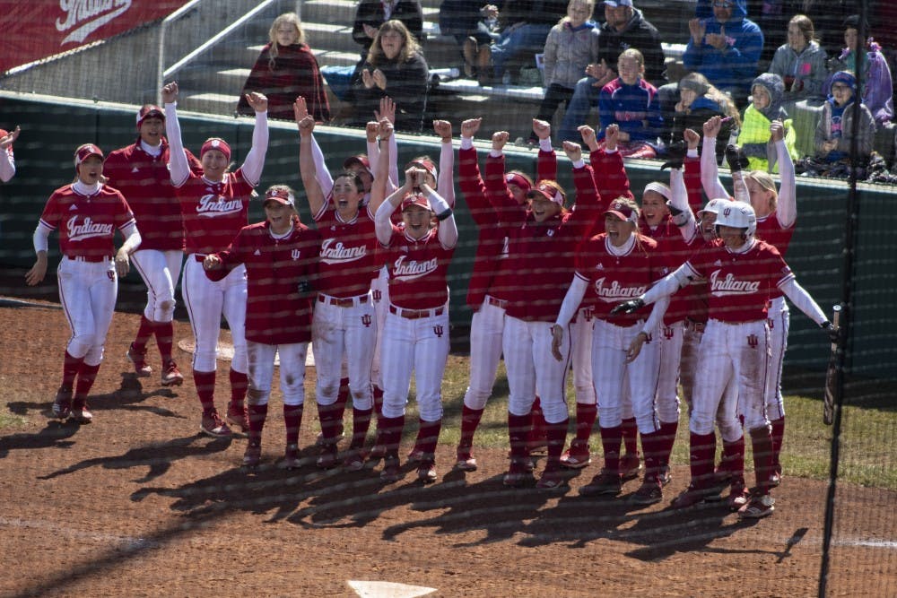 <p>The IU softball team cheers on then-sophomore Grayson Radcliffe on March 17, 2019, after she hit a grand slam against Saint Francis University. The Hoosiers scored two wins against Wisconsin on Saturday, as well as a win and a loss against Minnesota on Sunday. </p>