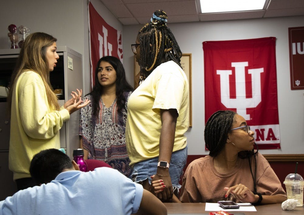 <p>Two IU Student Government members hold hands as they gather following an executive branch meeting. IU Student Government has begun the electoral progress for next year&#x27;s representatives. </p>