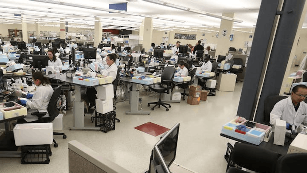 Lab workers log specimen samples at the Mayo Clinic Superior Drive facility in Rochester, New York in early March. A March 23 press release from the Office of the Vice President for Research announced only essential research activities could be conducted in person due to the coronavirus pandemic. 