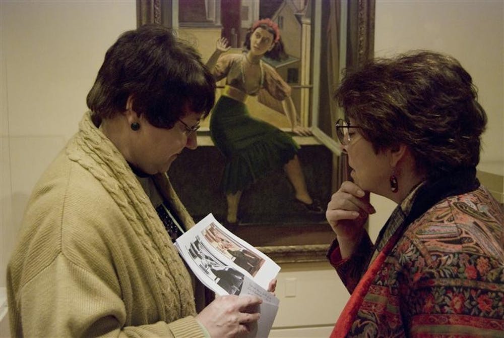 Docent Tina Jernigan shows the first and final copies of Balthus's The Window to Indianapolis resident Janice Mutch during a tour at the IU Art Museum Saturday afternoon. The tour, called Fashion Across Time, explored styles from early humanity to the Middle Ages to modern times.