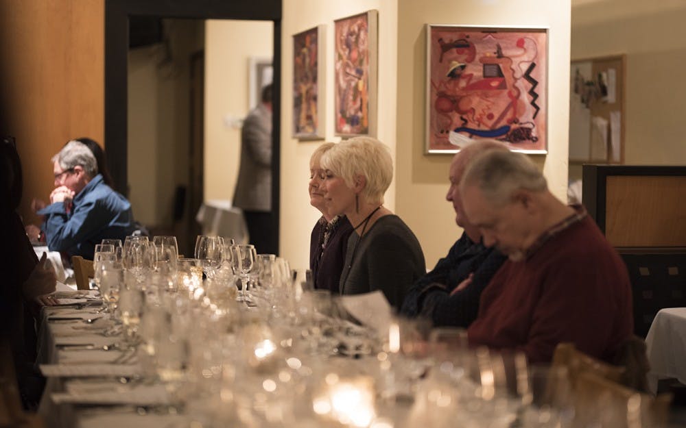 Terri Porter and Teresa Lehr talk to their friends as they wait for the five course meal at Truffles Restaurant to be served. The meal was part of the Bloomington Week of Chocolate Wednesday night. 