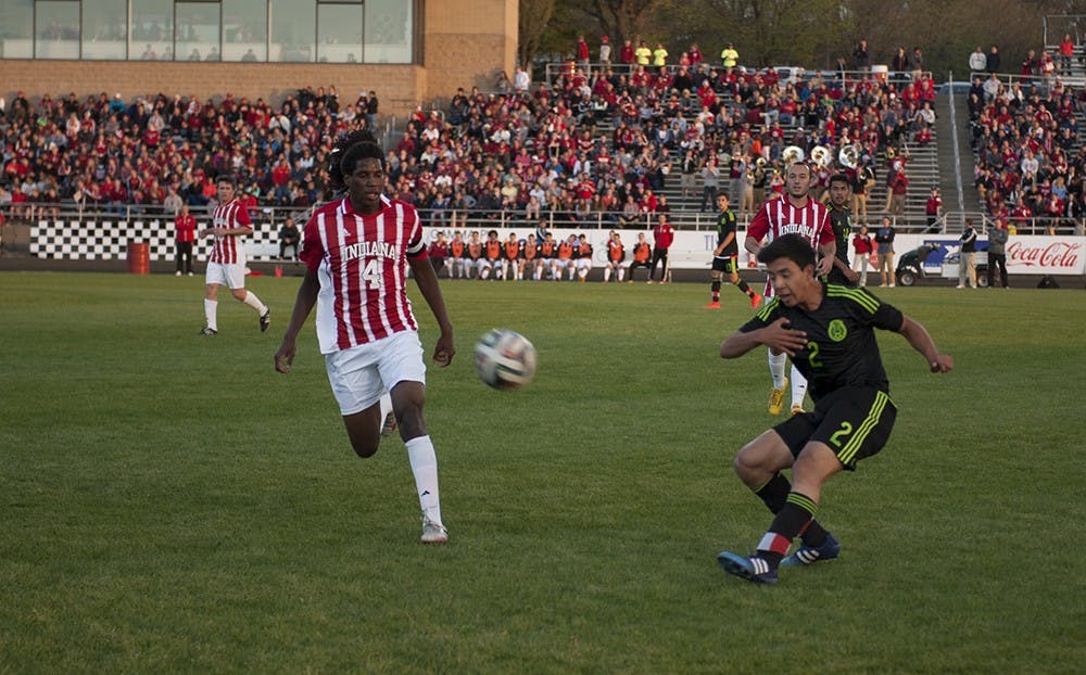Ulises Torres Méndez clears the ball under pressure from IU junior Femi Hollinger-Janzen on Tuesday at the Bill Armstrong Stadium.