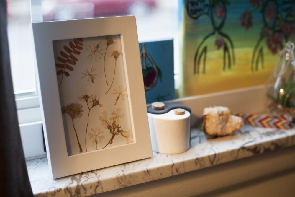 <p>A frame filled with pressed flowers sits on a window sill in Campus Walk Plantation South Apartments. Students can make things such as this to decorate their dorm or apartment in creative ways.&nbsp;</p>
