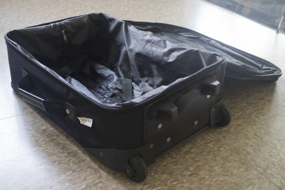 A suitcase sits open on the ground May 17 in University East Apartments. 