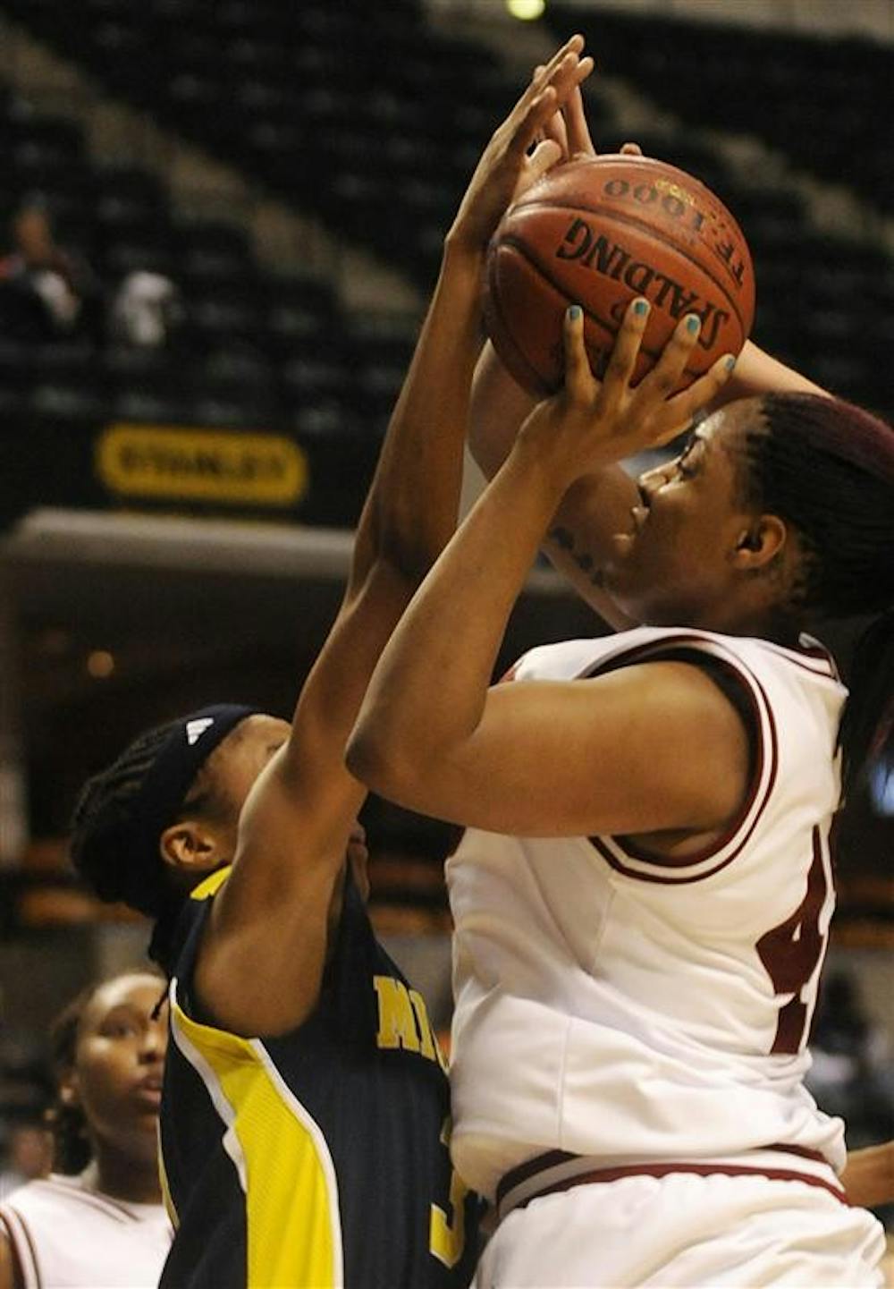 IU senior forward Amber Jackson puts up a challenged shot during the second half of IU's 68-50 win against Michigan in the first round of the Big Ten Tournament on Thursday at Conseco Fieldhouse in Indianapolis. Jackson had 15 points.