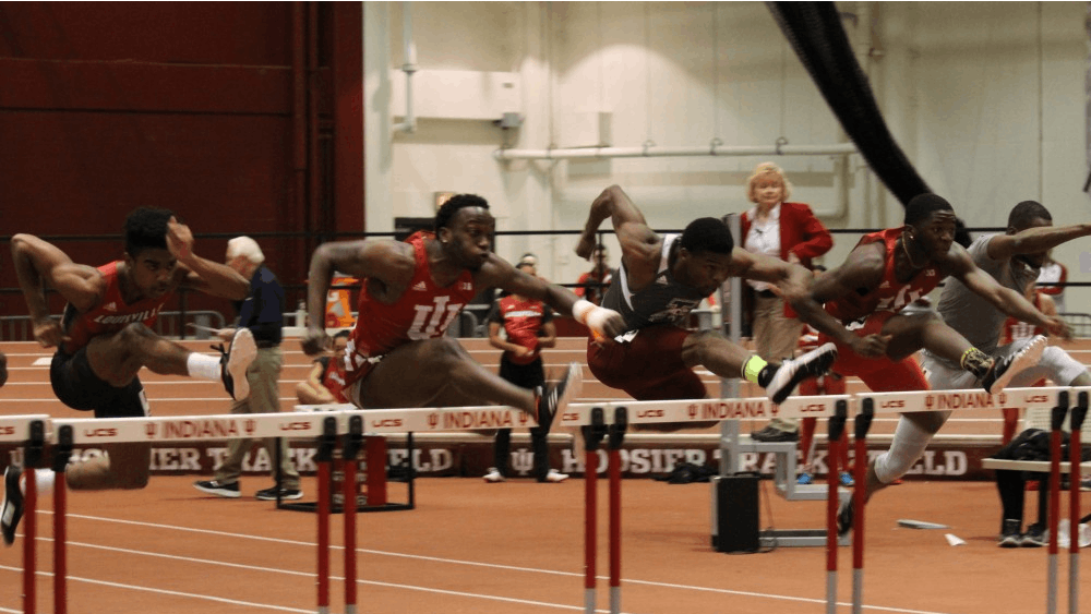 IU hurdlers William Session and Moses Baryoh jump the first hurdle in the 60-meter hurdles at the 2018 Hoosier Hills meet. Session earned first place with a time of 7.68.