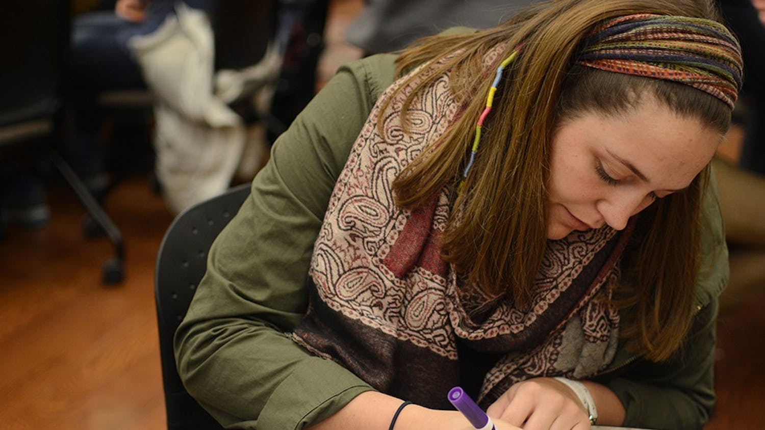 Madison Wise, junior student of IU, makes valentine cards during the event held by the college internship program and Autism Mentoring Program (AMP). Ali Matisko, student intern at AMP, said this event intent to spread awareness of autism and students with special needs.